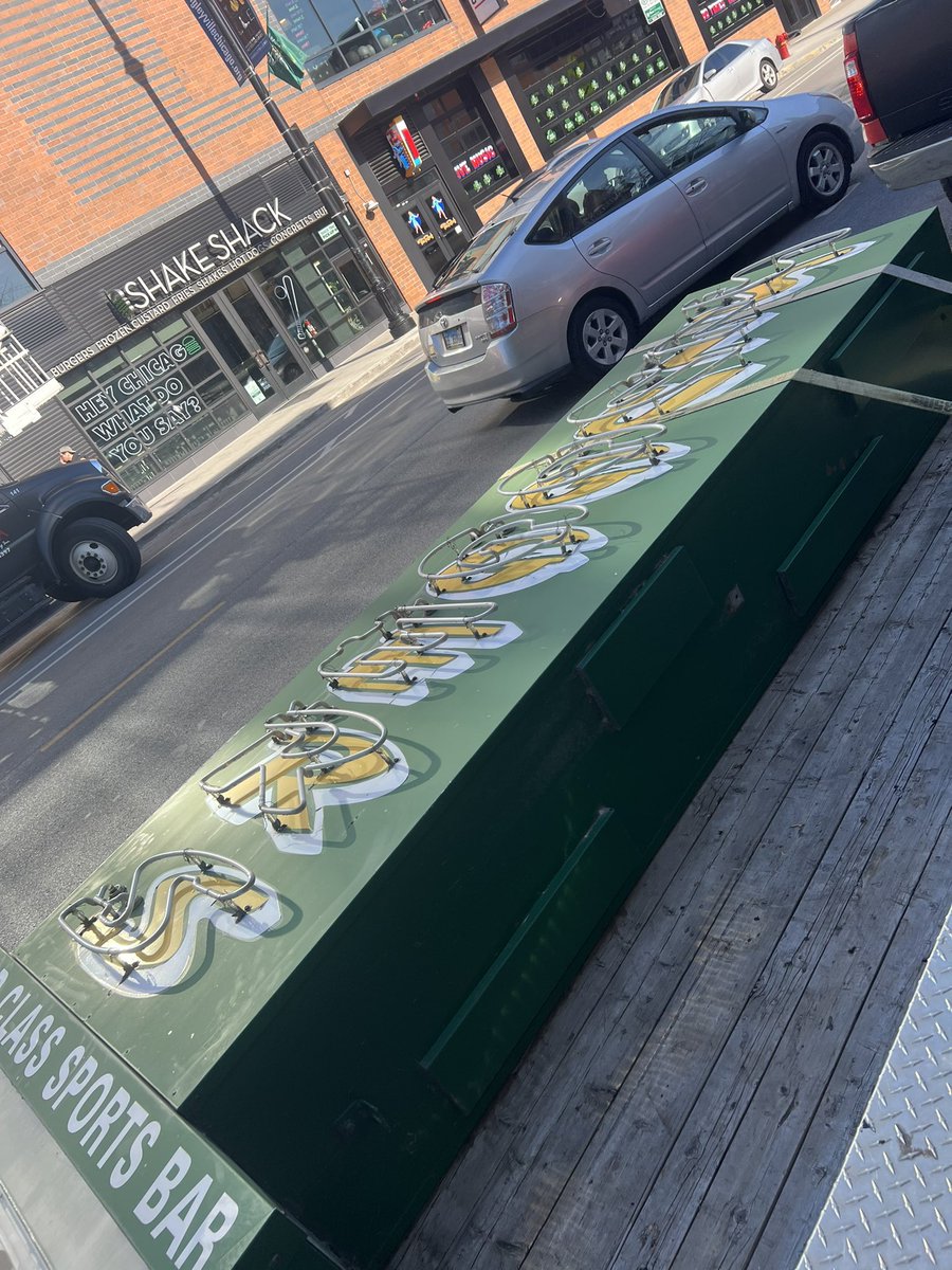 wischlist's tweet photo. The iconic sign at Sluggers on Clark Street in Wrigleyville is coming down and being replaced by a new one. 

I asked a worker where the old one is going. He didn’t know. I said the Chicago History Museum would be a cool destination. He agreed. ⚾️ 🍻 https://t.co/ZdCuVuwyuT