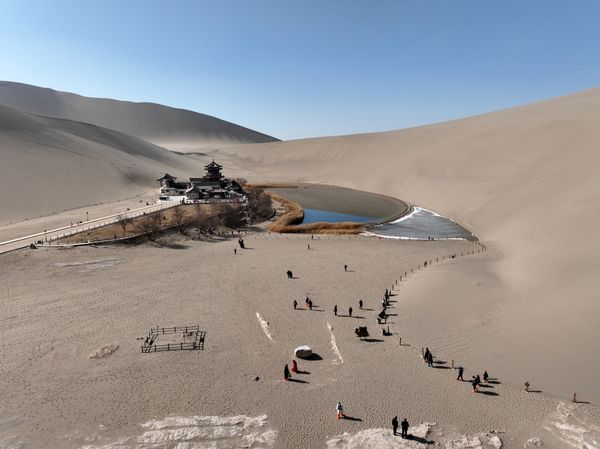 The  waters of Crescent Moon Spring in Dunhuang, Gansu Province glistened  amid the sand dunes of the Mingsha Mountains and the Gobi Desert. [Photo: VCG] #2024ChinaAgenda #Travel #EcoFuture #EcoCivilization