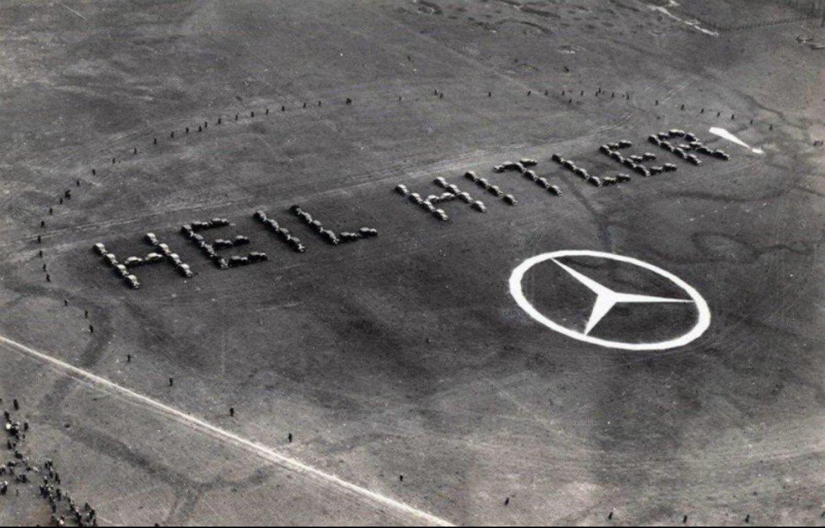 Mercedes-Benz greets Nazi airplanes with a “Heil Hitler!” salute at the Daimler-Benz factory, 1936.