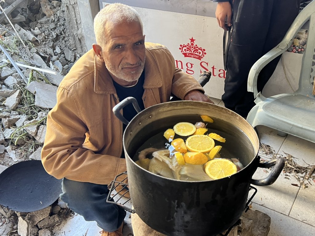 AbujomaaGaza's tweet photo. To persuade his wife to break her fast in the south of #Gaza:

1- He spent two days looking for someone having a chicken.

2- He insisted to take a picture beside it.

3- He did not eat anything from it because it belonged to an 18-member-family.

4- He sent it to his wife’s mobile in the south of #Gaza.

5- He lied on her and told her that he still have enough money to buy and eat chicken and meat.

This happened in front of me and I took the picture for him myself.