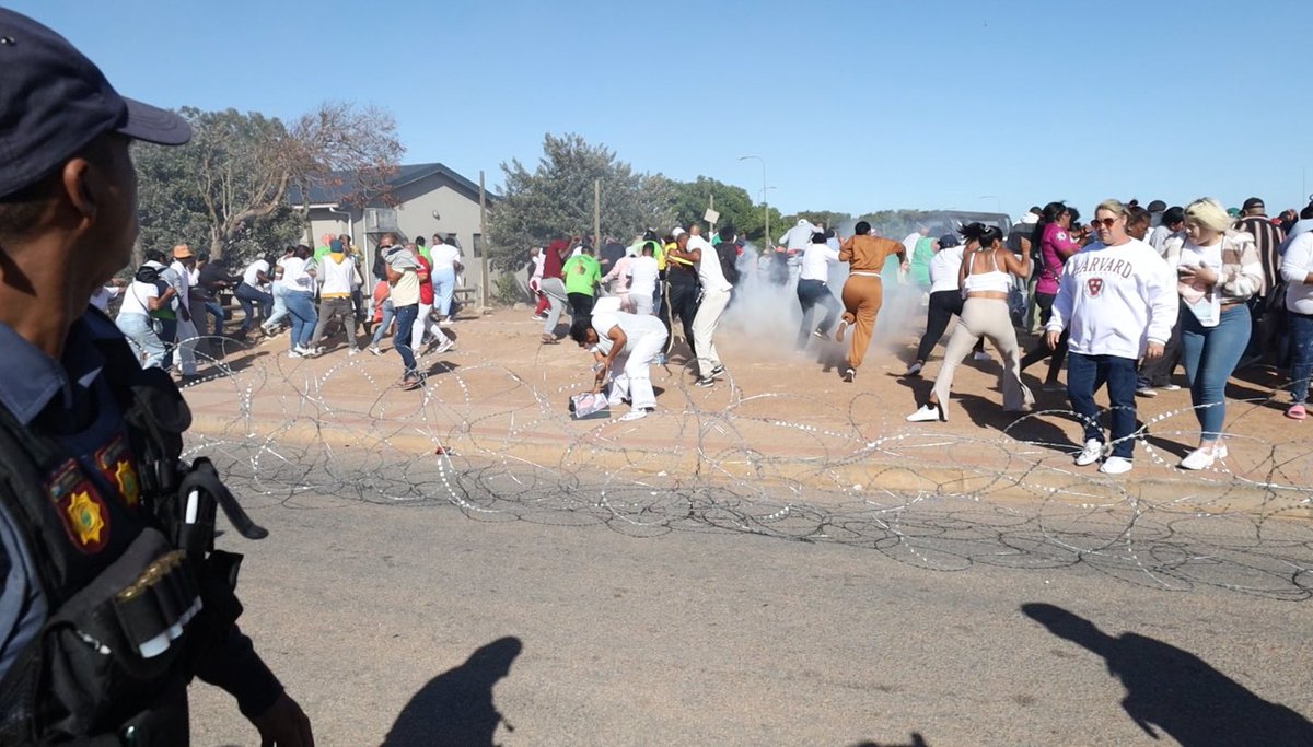 „They treat us like animals“, people shout in front of Vredenburg Magistrates Court. „Where was police when Joslin disappeared“? Police used tear gas to clear area before delayed bail hearing starts.