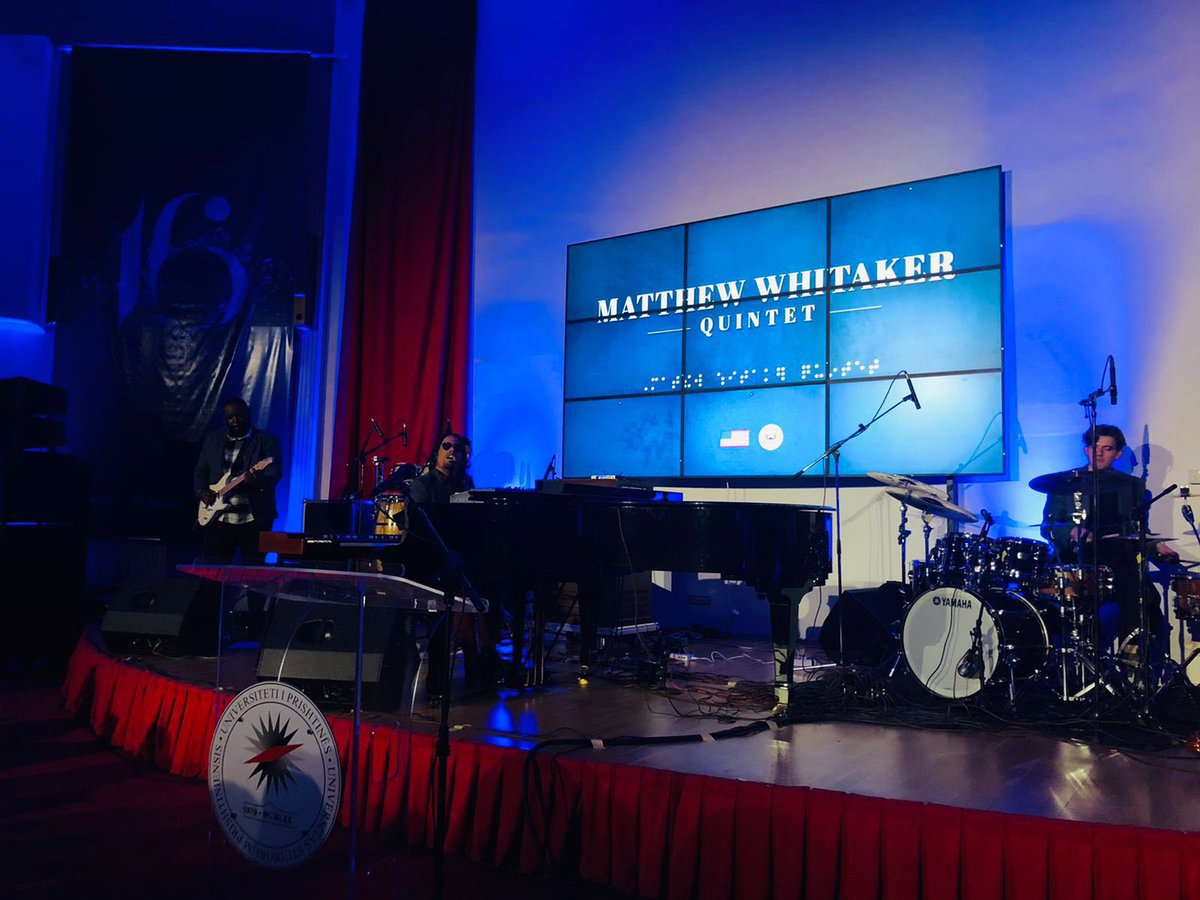Rektorati's tweet photo. 🎹 Matthew Whitaker, the renowned American jazz pianist, lit up UP's Library amphitheater in a concert hosted by the U.S. Embassy in Prishtina. 🌐 UP welcomed Prof. @qerimq and a vibrant crowd from the Faculty of Arts. 🎓 #IamUP #UPgrade #UPmusic 🎶 https://t.co/1QtTLC2kgn