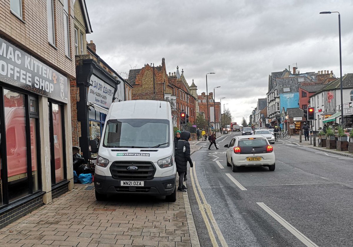 If vehicles are on pavements, where do the pedestrians belong?

Cowley Road