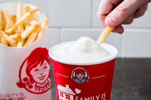 An dips their fries in ice cream