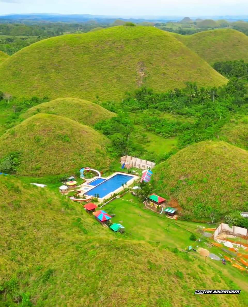 pinasnowTV's tweet photo. Controversy brews as resort near Bohol's UNESCO Heritage Geopark sparks outrage by being built close to iconic Chocolate Hills,a National Geological Monument since 1988.Despite drawing tourists,construction near one hill in Sagbayan receives backlash. #ChocolateHills #UNESCO https://t.co/l7p6FFQmdd