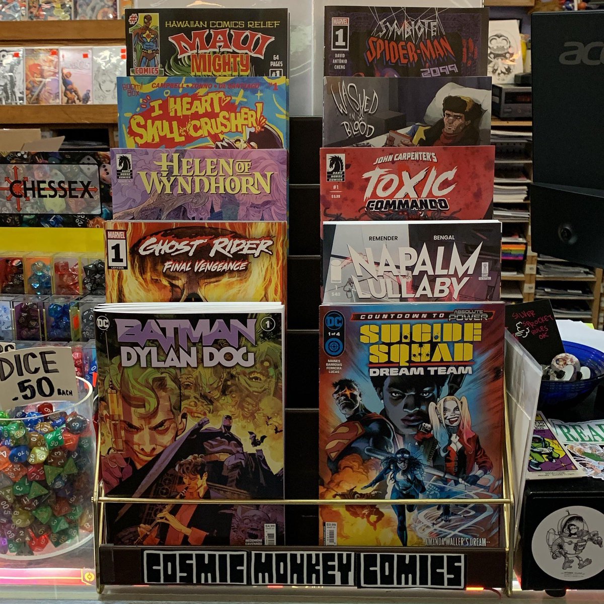 Our featured comics rack is packed with great new titles! #batmandylandog #suicidesquaddreamteam #ghostriderfinalvengeance #napalmlullaby #helenofwyndhorn #johncarpenterstoxiccommando #iheartskullcrusher #washedintheblood #hawaiiancomicsreliefmauimightycomics #ncbd #comics