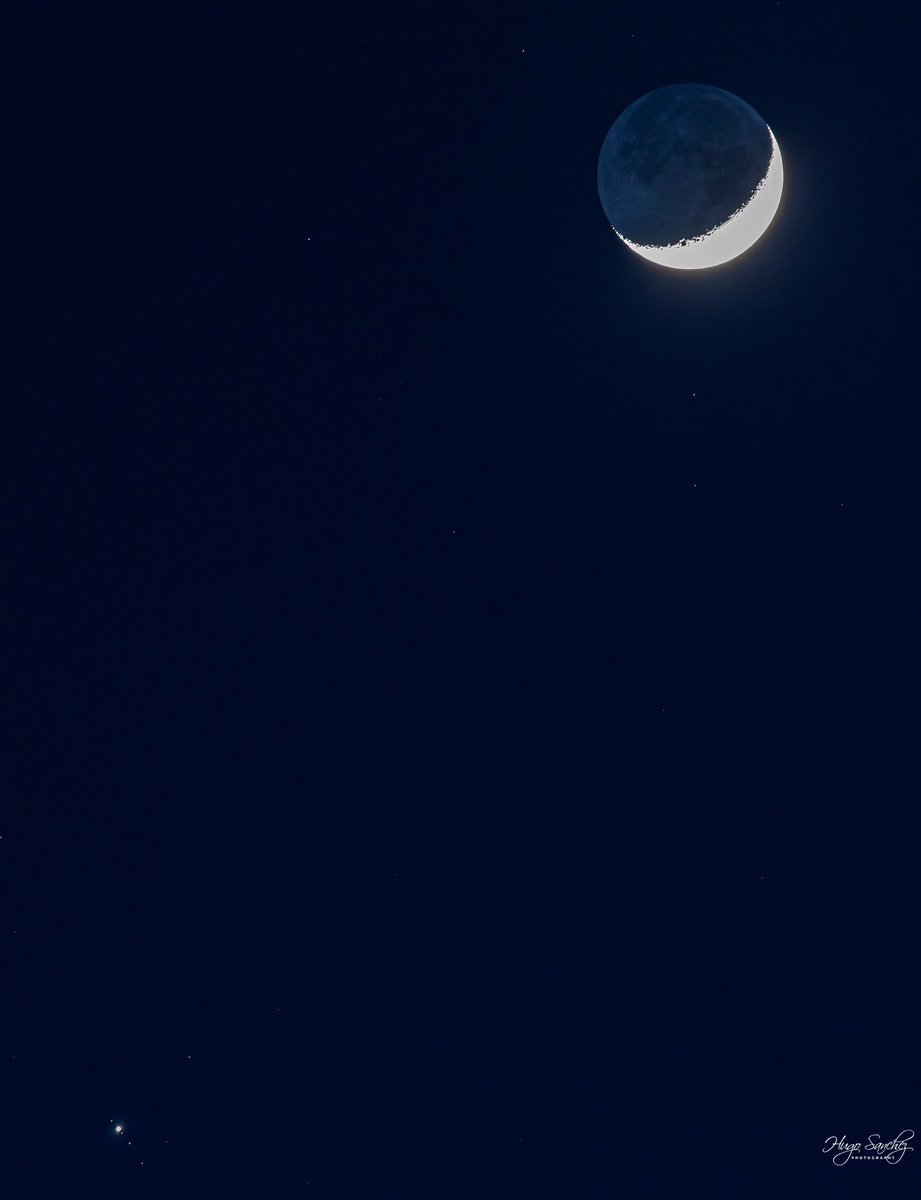 Crescent moon at 19.8 percent and Jupiter and three moon at bottom left. Edmonton. March 13.
