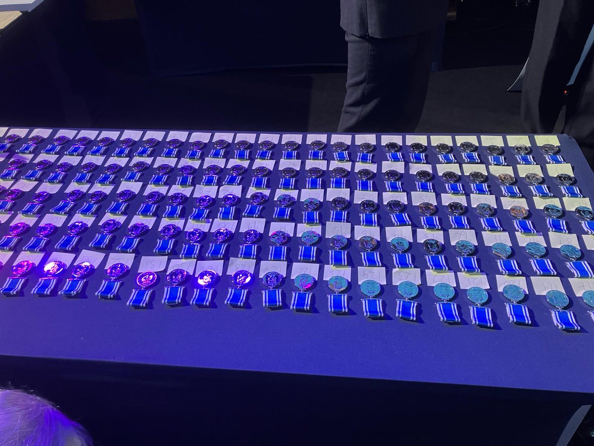 MetPoliceChoir's tweet photo. Yesterday the MPC (some choristers pictured) sang once again at the monthly commendation ceremony for officers receiving their 20 years' meritorious service medals. There were an awful lot of them - as you can see from the table of medals. 130 to be exact. Great time had by all! https://t.co/wvTBqmwmHz