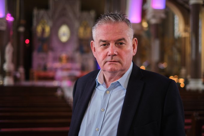 Kevin Magee, pictured standing inside a church.
