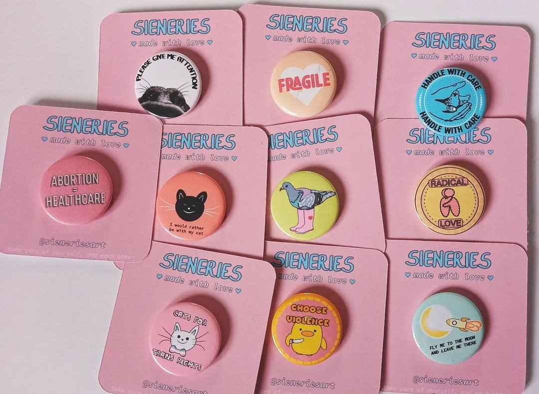 a peak at some other badges i've been creating ft. some nice pastel pink backings 🩷