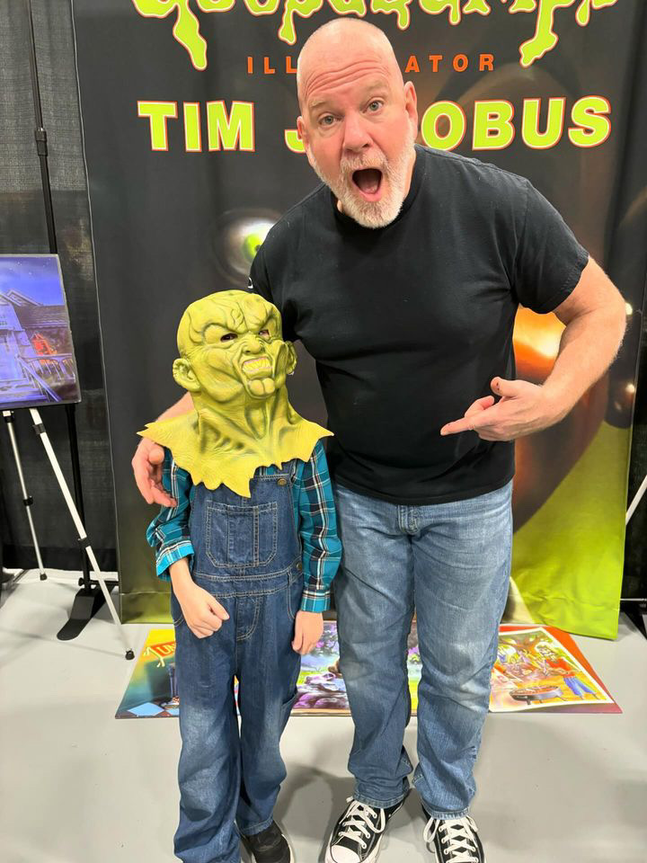 Here is Goosebumps original cover artist, Tim Jacobus. Watch for Tim at ComicCons everywhere! Here he is with a good-looking little fan...