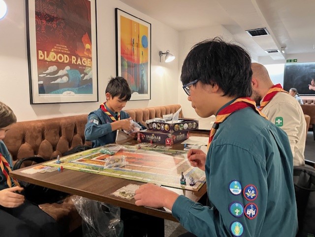 Our Scouts enjoyed a thrilling evening at <a href="/ThirstyMeeples/">Thirsty Meeples</a> recently.
Fuelled by cake and sweets the Scouts competed against each other with a selection of familiar and new games.
Expert advise from the staff helped choose the games and adjudicated - the Scouts had a great time!