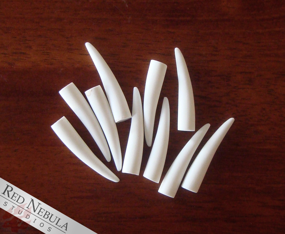 Resin cast 2 inch thin fangs, available raw or cleaned up, and in black or white. - Robbie.