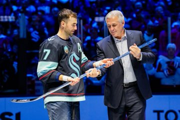 Photo of Jordan Eberle receiving a silver stick from Ron Francis 