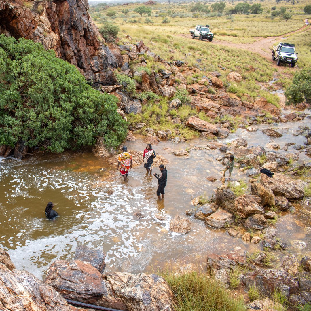 KJMartu's tweet photo. During big rains, #KJMartuRangers took younger #Martu to visit Parnngurr Rock Hole. #OnCountry day trips deepen the younger generations' connection to their culture + Country. The #KJRangers share language + knowledge of places visited, contributing to #KeepingCultureStrong. https://t.co/HXVPLNXh52