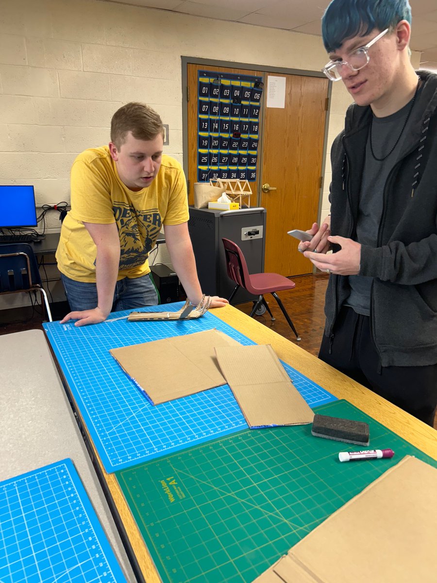 PLTW students are building robotic hands. They have to be able to pick up a marker, water bottle, eraser, and plate!