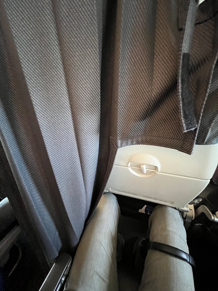 jamopeterson's tweet photo. So when you’re 6ft 9” and @British_Airways cancels the exit row seat you’ve paid for, because they’ve sold it to club, they don’t say anything and then adds insult to injury by draping club curtain over you and leaving your exit row seat empty https://t.co/VW111xXLUO