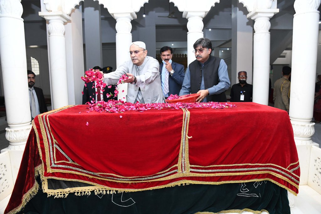 LARKANA: March 15 - President Asif Ali Zardari showering flowers on the grave of Shaheed Mohtarma Benazir Bhutto at Garhi Khuda Bakhsh Bhutto