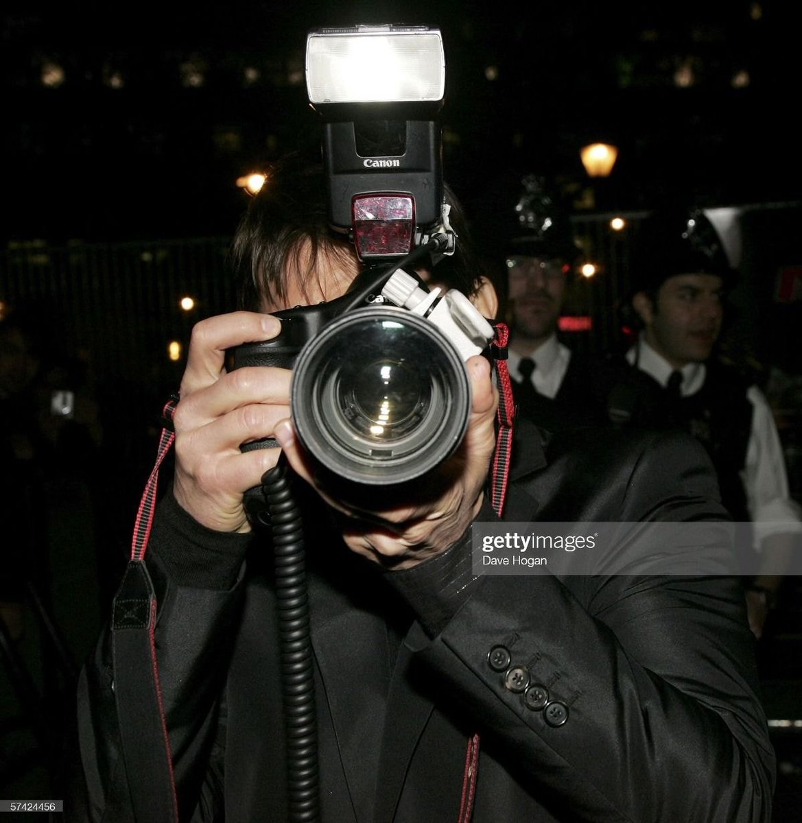Tom Cruise borrows a camera from a photographer to photograph the press at the UK Premiere of MissionImpossible3