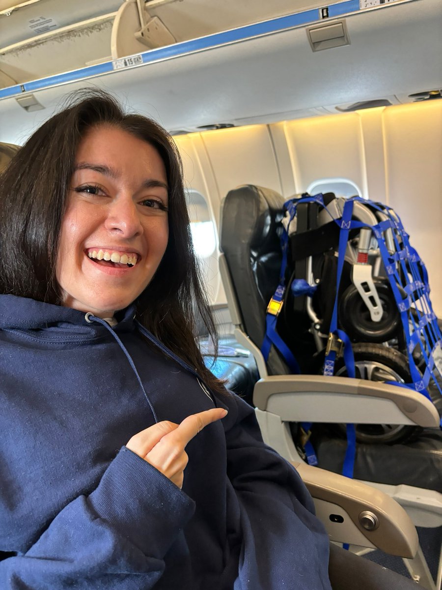 I’m seated next to a unique passenger on my flight today. Check out my travel wheelchair seat strapped right on board! #RightsOnFlights