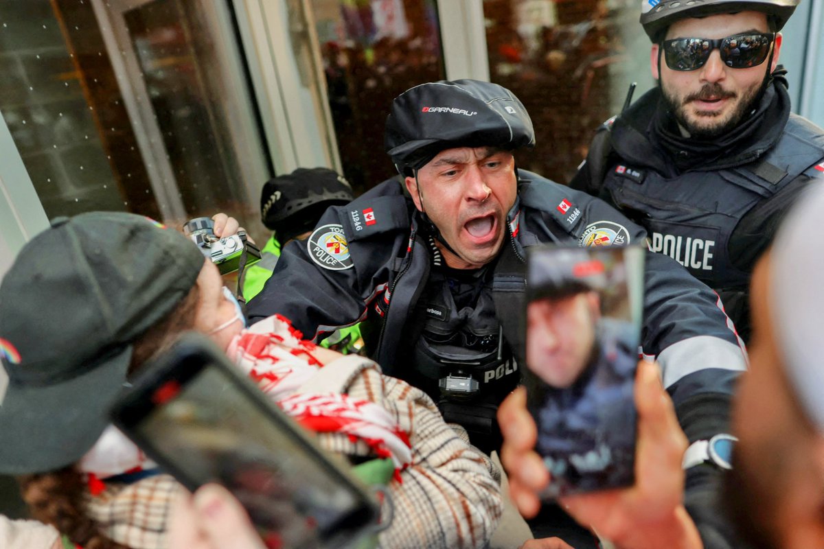 Police officers scuffle with supporters of a ceasefire in Gaza protesting near the venue of a Liberal Party fundraising rally for Canada's Prime Minister Justin Trudeau in Toronto. Photos for @Reuters