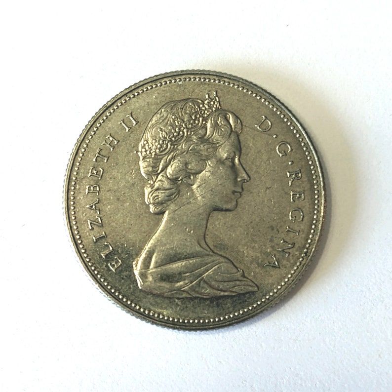 Own a piece of Canadian history with this vintage 1971 FIFTY CENT PIECE featuring Queen Elizabeth II. This 53-year-old half dollar coin is a rare find. #CanadianCoins #VintageCurrency etsy.me/43eJhya