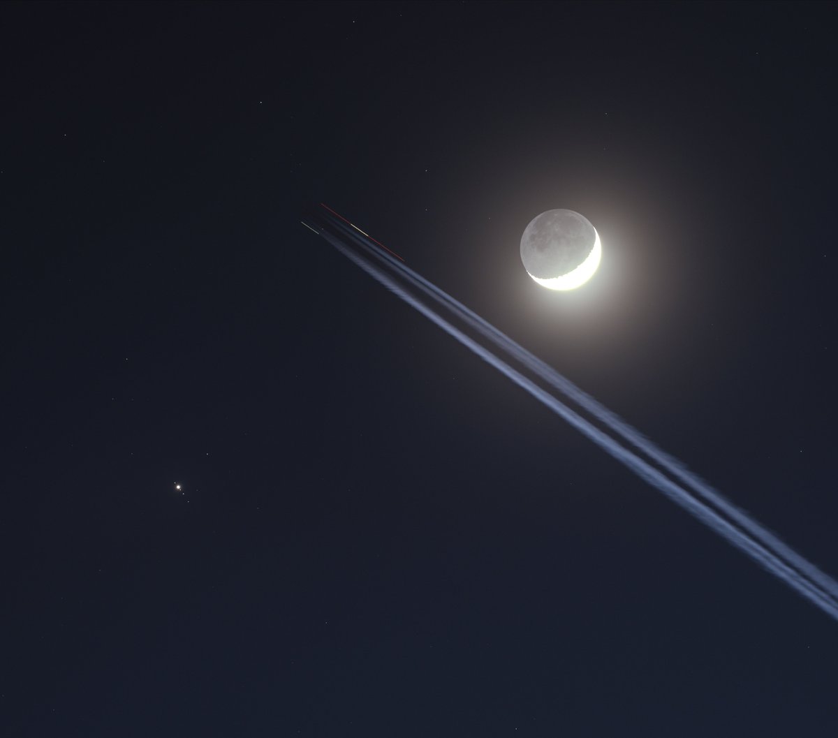 A plane flew directly between the crescent moon and the planet Jupiter in the sky! This is a one-second exposure through my telescope on Wednesday night.