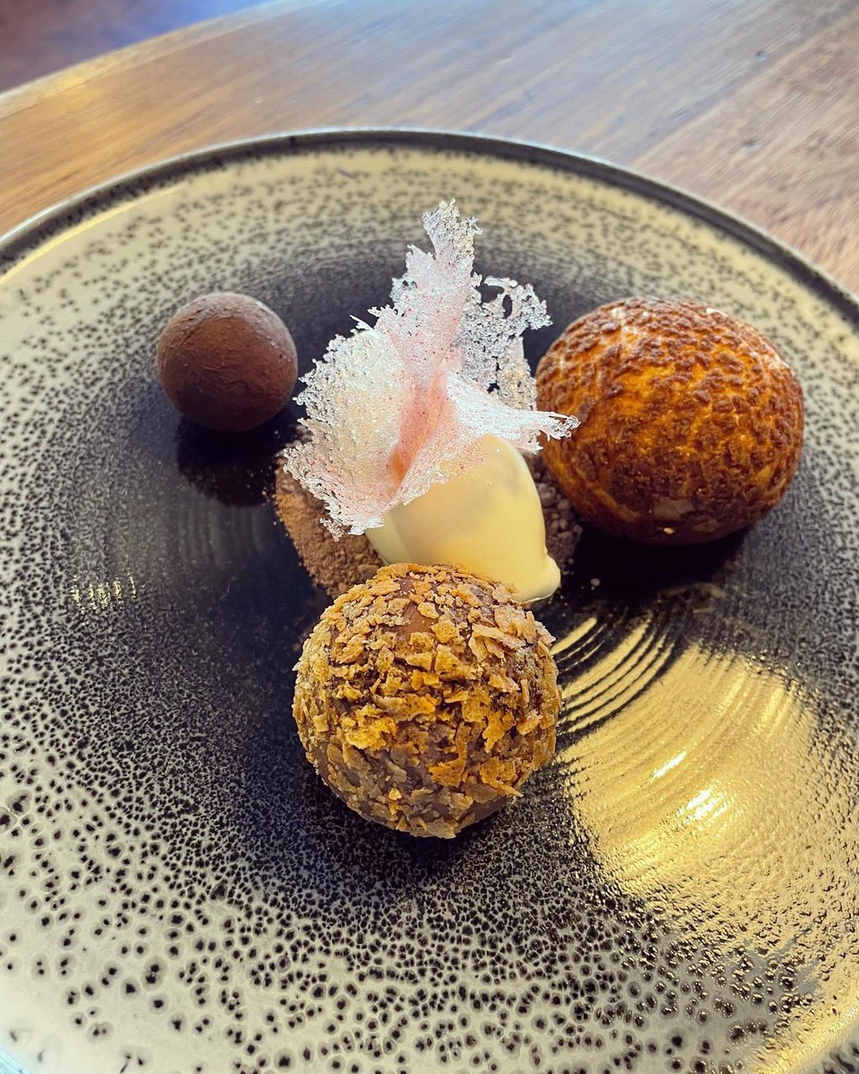 Creamy chocolate choux craquelin with a chocolate coated les tres leche ball, caramelised chocolate sphere, goats milk ice cream and a raspberry isomalt tuille! #aldeburgh #suffolk #dessert #pastry