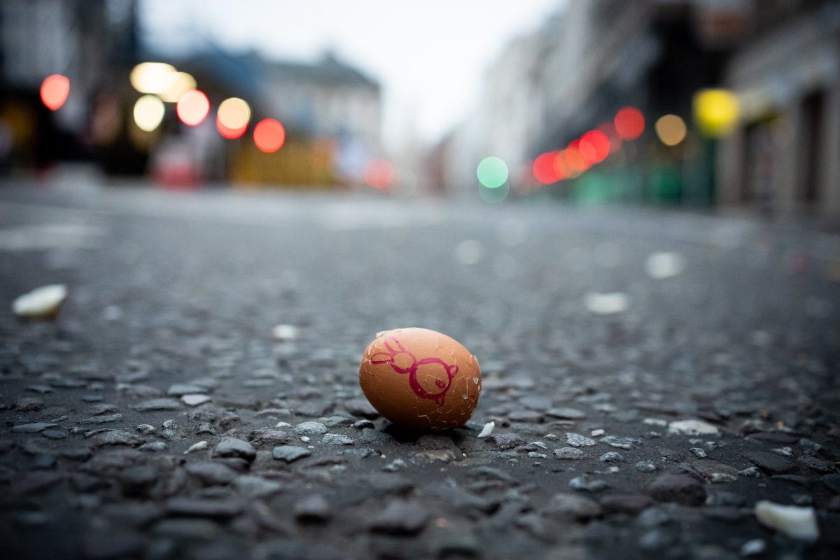 People take part in rolling hard boiled eggs on Fleet Street outside St Bride's Church, in London, following the kindling of the Easter Fire and the dawn service at the church.