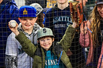 Photo of two young Mariners fans smiling. 