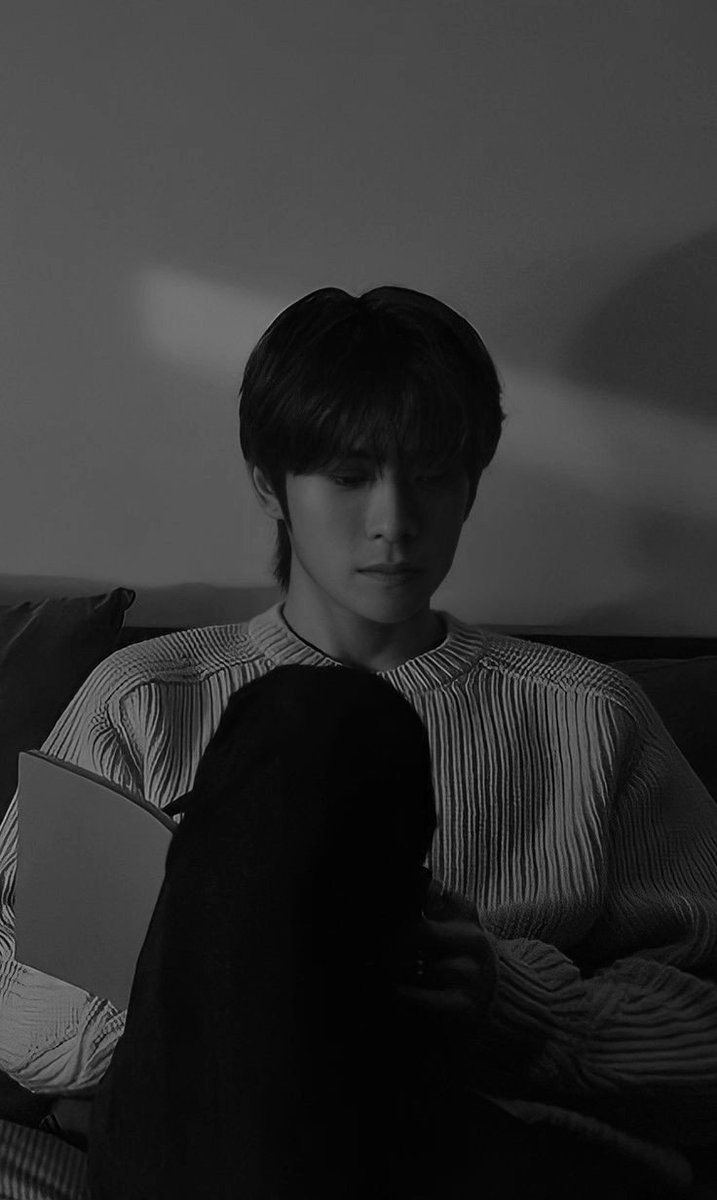 With the soft glow of his device illuminating his features, juxtaposed against the warm ambient light cascading through the room, he embodies the modern-day dichotomy of leisure and connectivity.