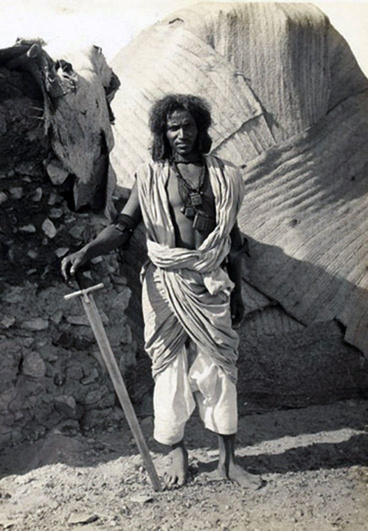 A Bishari man with his kaskara sword. Nubain Desert, vic of Aswan, Egypt, circa 1900.