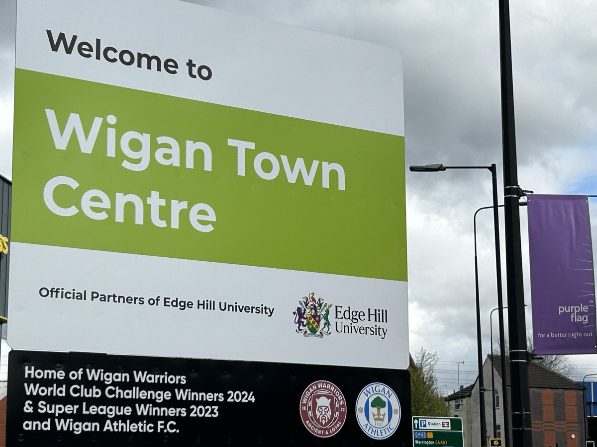 🍒⚪ Our town centre signs in Wigan have been updated 🏆 Good luck to the World Champion @WiganWarriorsRL this afternoon #WWRL #SLSTHWIG