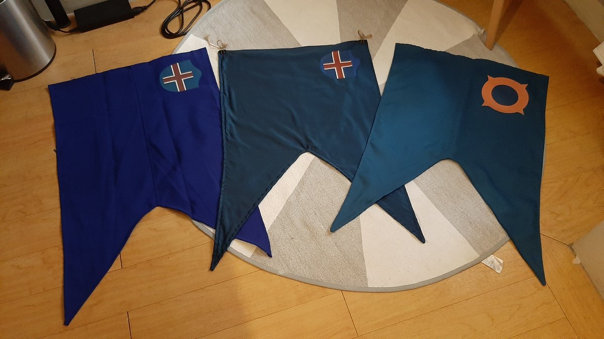 RAISdotra's tweet image. Evolution of the flag of Henuldia (formerly the RAIS), post-Protocol 24, where the old coat is replaced by the Sdarj'hed. While the new symbol will be featured on the blue banner, the old coat will remain in use alongside it.