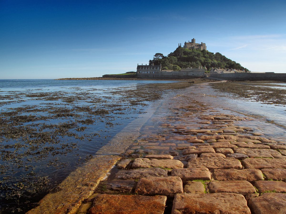 Huge cobblestones pave the way to St Michael's Mount a tidal island in Mount's Bay, Cornwall, England, . The island is linked to the town of Marazion by a causeway of granite setts, passable (as is the beach) between mid-tide and low water. Wikipedia & Me. NMP.