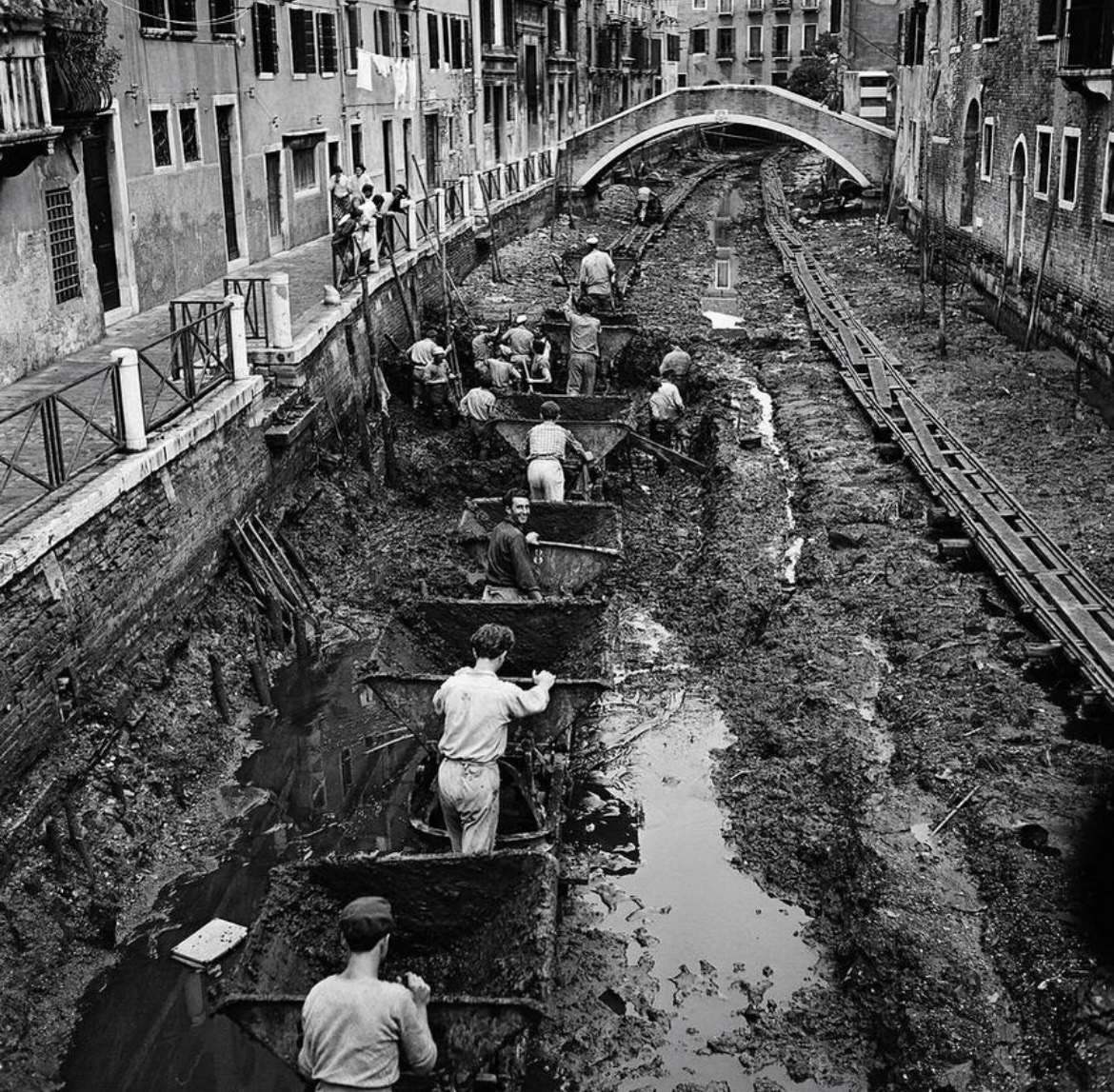 The grand canal is drained in order to allow it to be cleared of silt and mud. Venice, 1956.