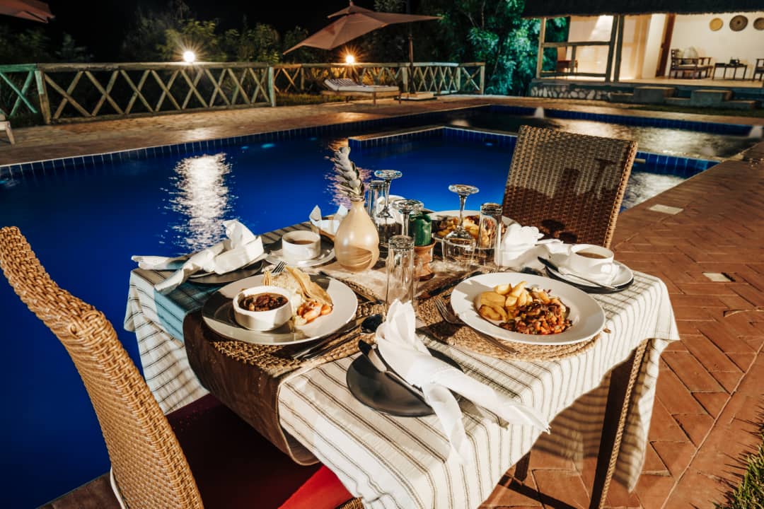 Dinner by the poolside. Dishes. Drinks. Delights. Book your Easter stay with us on ☎️ 0789 390 350. @TourismBoardUg @ExploreUganda @ugwildlife #KnowYourPark #ExploreQueenElizabethNationalPark #KikorongoSafariLodge