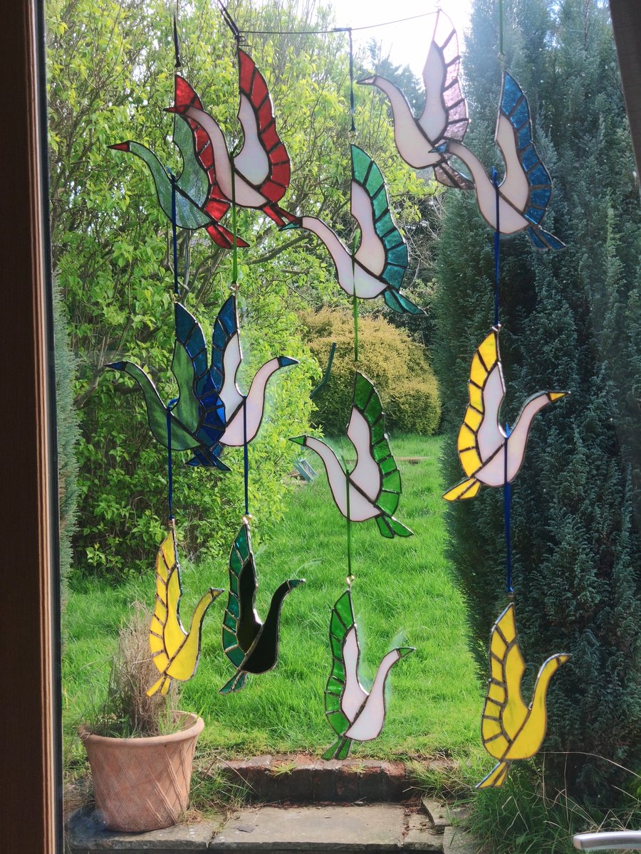 A bakers dozen stained glass cranes from #dolittleglass. Inspired by the Japanese 1000 cranes story. #1000cranes I'm making these for display and sale during Warwickshire Open Studios #Wos2024 Proceeds will be donated to charity.