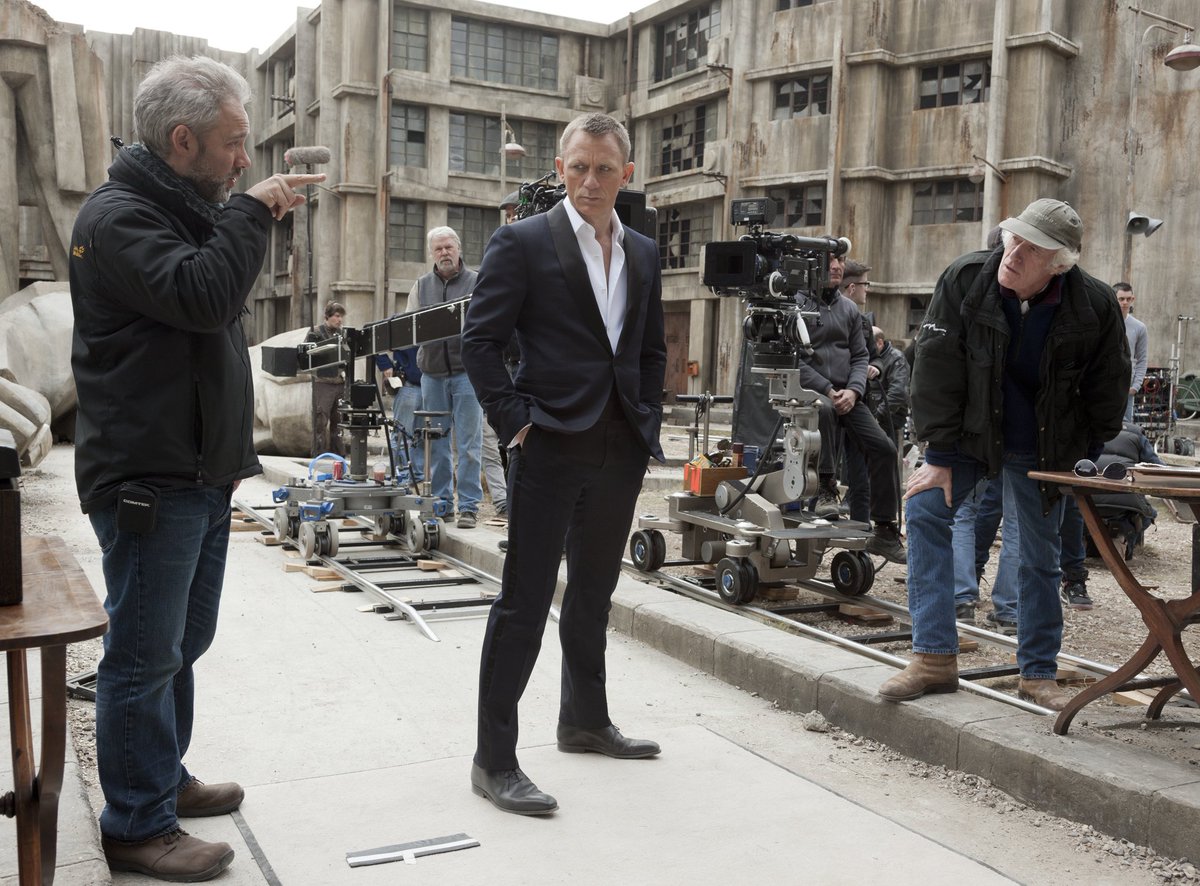 007's tweet photo. Pictured on this day in 2012, Daniel Craig (James Bond) and Javier Bardem (Raoul Silva) filmed on the SKYFALL Dead City set at Pinewood Studios. https://t.co/d0z5l34y5C