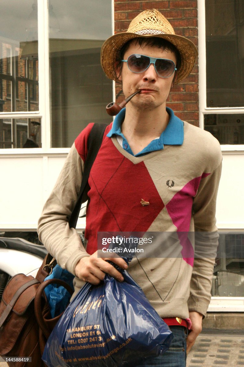 Rock and roll Pete Doherty taking a walk around Brick Lane looking more like Tony Benn with his pipe than a crazy rock wildman (2006)