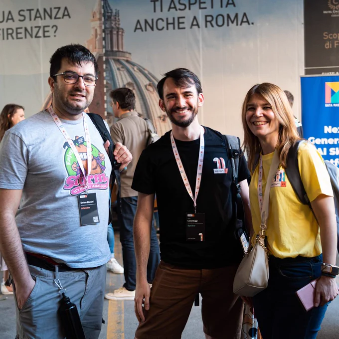 A group photo of three people: two men and a woman.