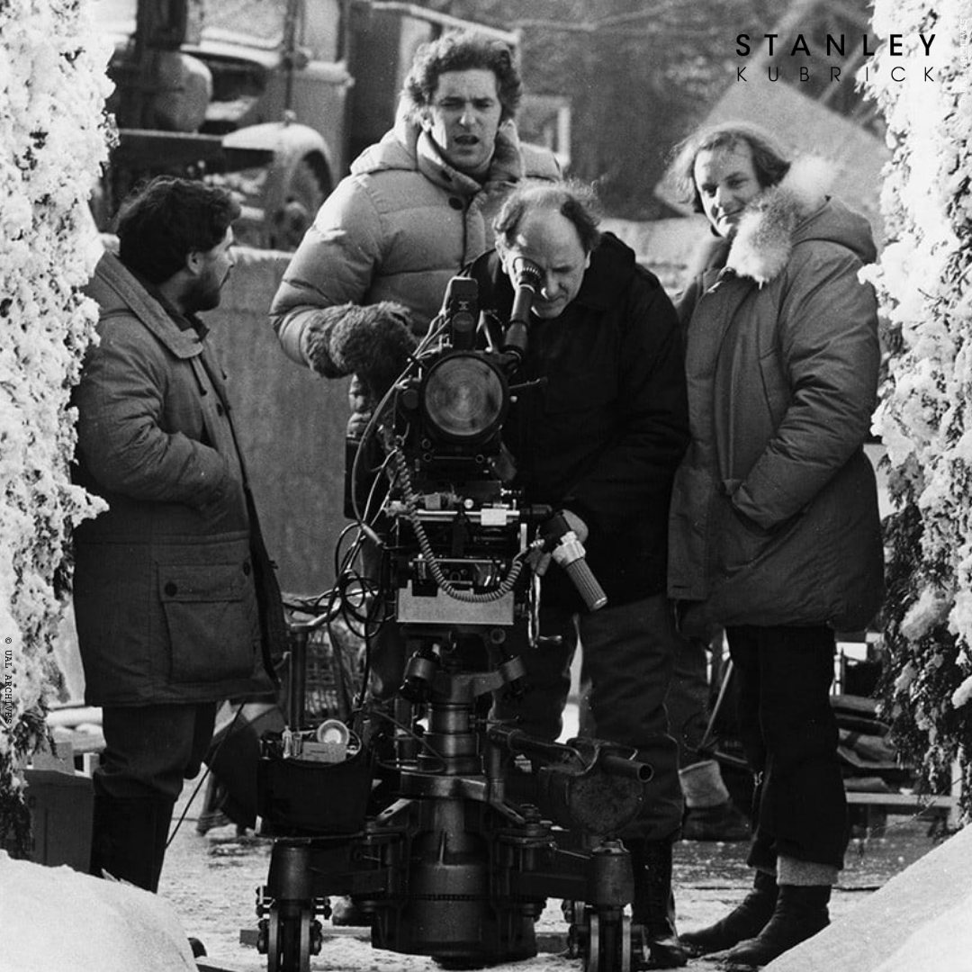Camera operator Kelvin Pike and focus puller Douglas Milsome examine a dolly setup on the maze set of #TheShining at @elstreestudios. Standing by are grip Dennis Lewis and AD Brian Cook.