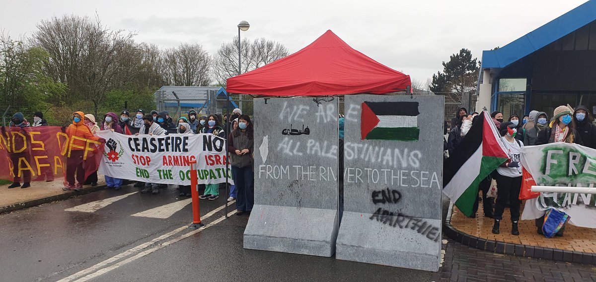 Pro-Palestine protesters block access to GE Aviation in Cheltenham, claiming the factory 'arms genocide'. #Cheltenham #Gloucestershire