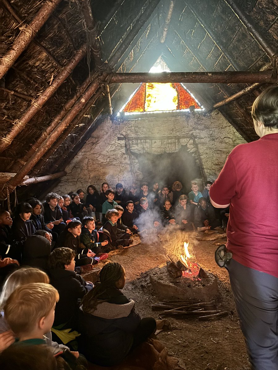 Year 3 are having a talk in a real roundhouse with an authentic heat source! @butserfarm