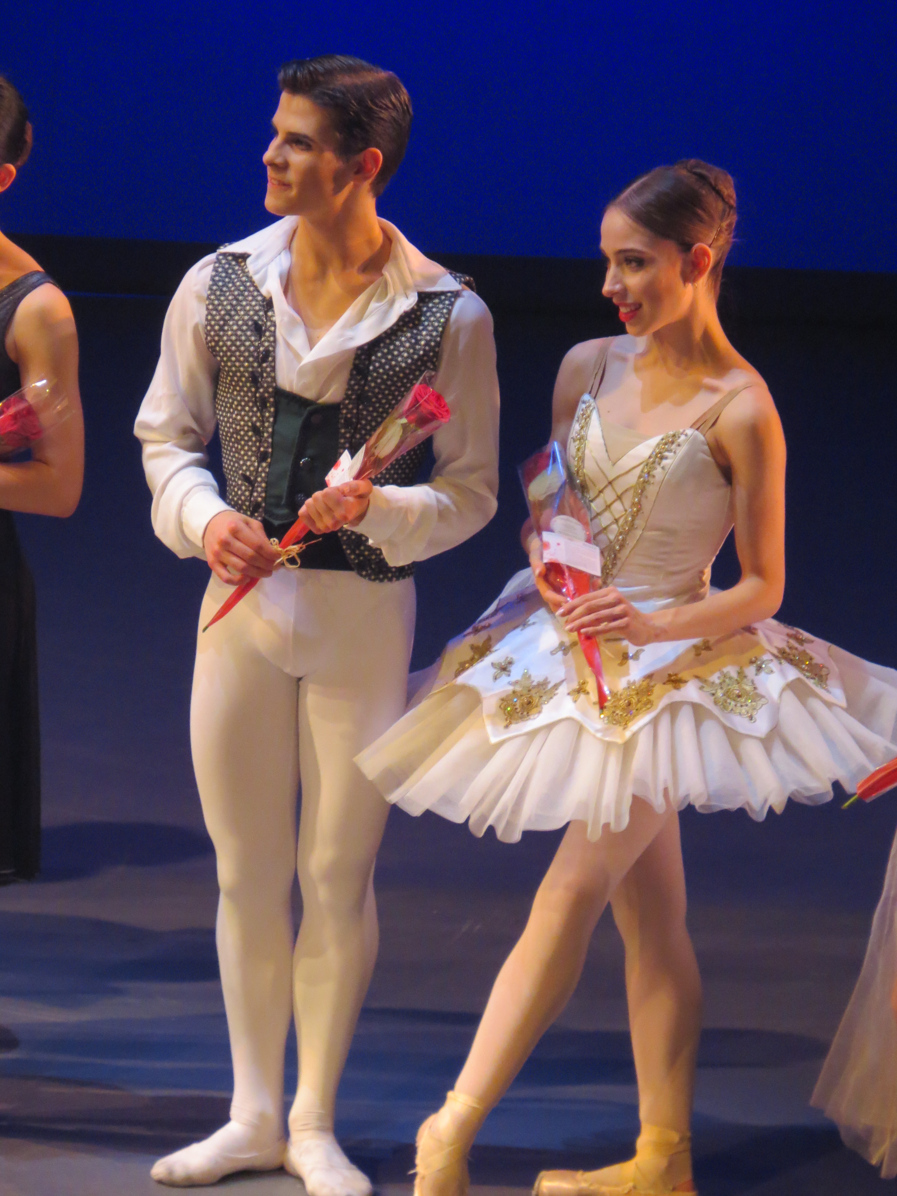 Photo shows 2 young dancers from Bavarian State Ballet Antonio Casalinho and Margarita Fernandes both are watching the awards being presented and both have a red rose which they received after the show.