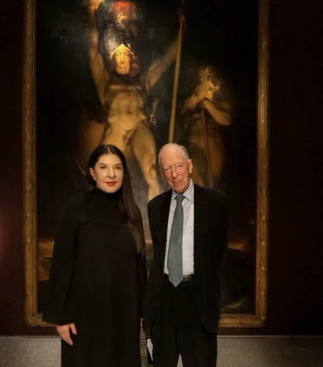 Jacob Rothschild in front of a painting of Lucifer