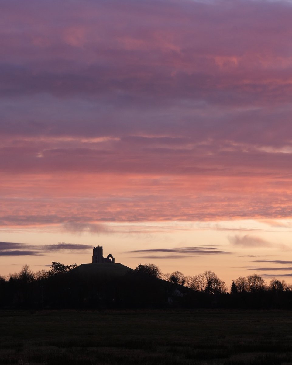 Pastel hues colour the sky as a spring morning begins at Burrow Mump on the Somerset Levels. 📸 @sambinding #SpringEquinox #VisitSomerset