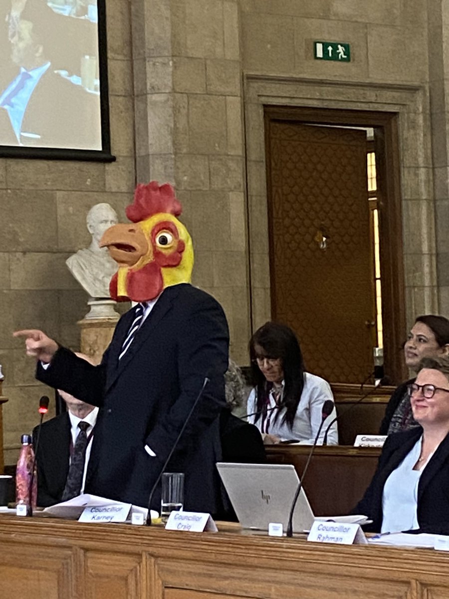 Labour Councillor Pat Karney wears a chicken mask to a Manchester City Council meeting to demand Rishi Sunak to call an election (2024)
