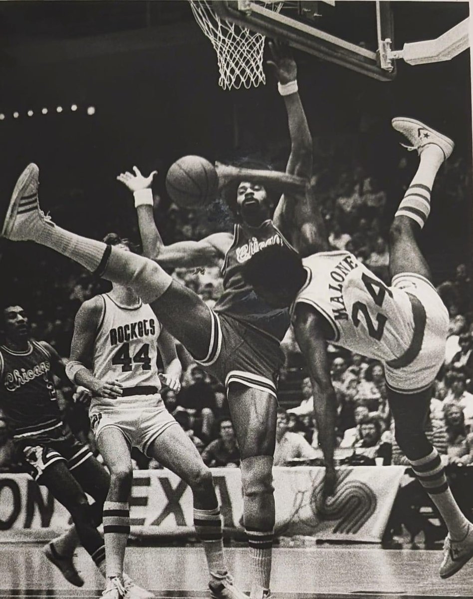 Artis Gilmore and Moses Malone colliding under the boards.