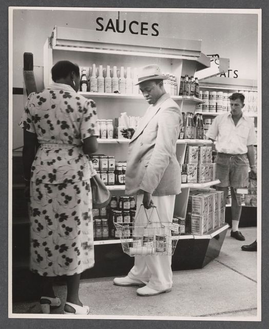 Stylish Lagos residents perusing the gourmet section at the Kingsway store in Lagos, browsing through the meticulously arranged aisles marked 'Sauces' and 'Fats.' Circa:1940s

Image Credit: Duckworth, E. H., 1894-1972 

 #ThrowbackThursday#ASIRIMagazine #historyoflagos
